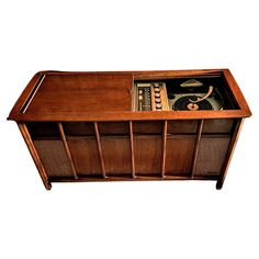 an old wooden radio with some music in it's drawer, on a white background