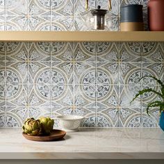 a kitchen counter top with some fruit on it and a potted plant next to it