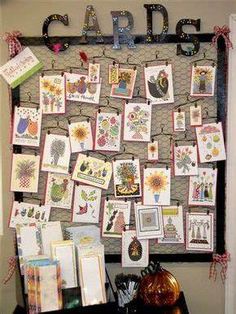 a bulletin board with lots of cards and pictures hanging on it's side wall