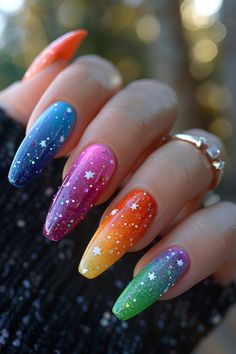 A clear base with small star shapes painted in different colors for a celebratory sky. Chakra Nails Designs, Funky Colorful Nails, Edm Festival Nails, Glow Nails Design, Nail Design For Birthday, Pigment Powder Nails, Gold Butterfly Nails, Squoval Nail Designs, Squoval Nails Design