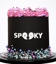 a black cake with spooky frosting on it's top and the word spooky spelled in white