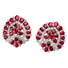 Created by Bulgari, Rome in the 1960s, these platinum clip earrings set with around 19.00 carats of rubies and 5.00 carats of diamonds date from the 1960s. Each omega clip back earring designed as a slightly domed and stylized Paan leaf is set with oval and round-cut rubies interspersed with round brilliant-cut diamonds. Dating from a period of profound transformation at Bulgari, these glamorous earrings represent a definitive step toward the firm's contoured, boldly colorful modern style. Produ Bulgari Earring, Bulgari Earrings, Glamorous Earrings, Bulgari Jewelry, Diamond Tops, 1960s Jewelry, European Jewelry, Traditional Indian Jewellery, Ruby Diamond