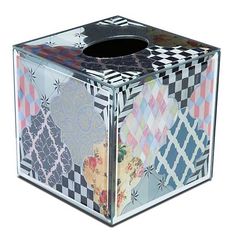 a tissue dispenser made out of multicolored paper with an artistic design