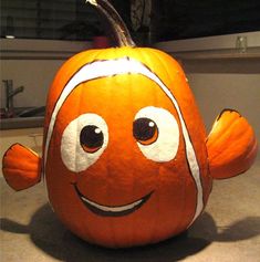 an orange and white clown fish pumpkin sitting on top of a counter