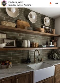 an image of a kitchen setting with white dishes on the shelf above the sink and wooden cabinets