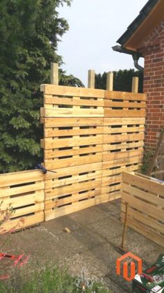 some wooden pallets in front of a brick building