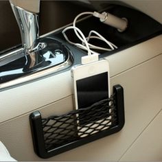 a cell phone is hooked up to a charger in the back of a car