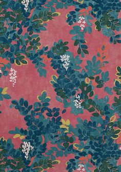 a pink and blue flowered fabric with green leaves on it's side, in front of a red background