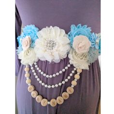 the belt is decorated with flowers and pearls