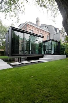 the house is surrounded by grass and trees