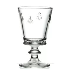 an empty glass on a white background with no people around it and one person standing in the middle