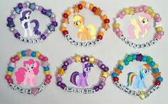 four little pony bracelets with name tags on them, all decorated in different colors