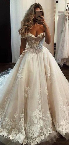 a woman is taking a selfie in her wedding dress while looking into the mirror