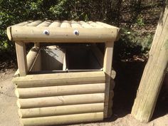 a wooden shelter with two eyes on it