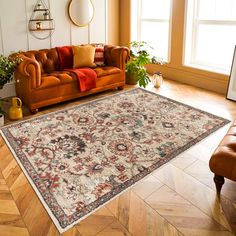 a living room with a couch, chair and rug