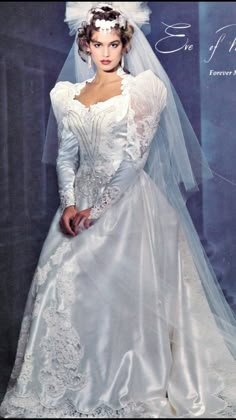 a woman in a white wedding dress and veil