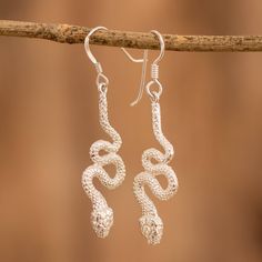 Often seen as sly and wise creatures, luminous snakes come from Costa Rica to add a luxurious accent to your style. Crafted by Paula Solano using the lost-wax casting technique, these dangle earrings are made from precious silver, with handy hooks that allow you to wear the accessories in all their glory. Handmade Elegant Snake Earrings, Elegant Handmade Snake Earrings, Silver Snake-shaped Earrings, Silver Sterling Silver Snake-shaped Earrings, Elegant Silver Snake-shaped Earrings, Elegant Silver Snake Earrings, Baroque Art, Lost Wax Casting, Silver Earrings Dangle