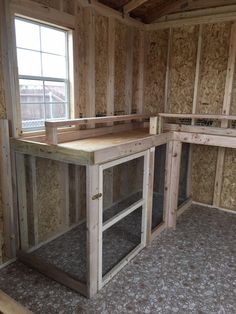 an unfinished kitchen with wooden walls and flooring in the process of remodeling