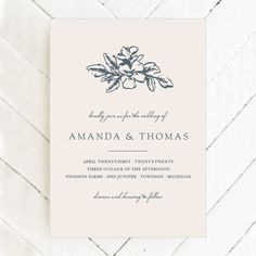 a wedding card with an elegant flower design on the front and bottom, in blue ink