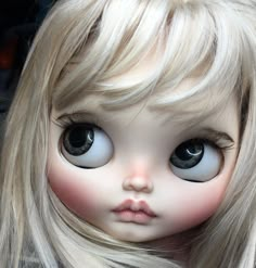 a doll with blonde hair and big eyes