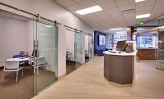 an office with glass walls and desks