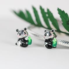 This is charm only, bracelet is sold separately.This cute Panda charm bead features a cute Panda holding a bamboo shoot. The Panda charm is made of solid 925 sterling silver and enamel colors to give it great details. Immerse yourself in the peaceful nature of these cute and playful Pandas. Add this sterling silver charm to your bracelet and elevate your style with its detailed design. Made with high-quality materials, it's a must-have accessory for any nature lover.Dimensions: 0.40 x 0.36 in Ch Panda Charm, Bamboo Shoot, Peaceful Nature, Detailed Design, Silver Charm Bracelet, Fine Jewelry Bracelets, Cute Panda, Pandora Bracelet, Bracelets And Charms