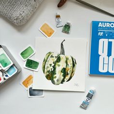 a white table topped with lots of paint and supplies