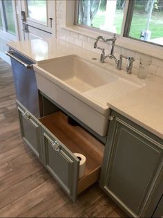 a kitchen sink with an open drawer underneath it