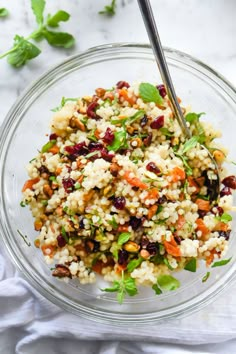 a glass bowl filled with rice and vegetables