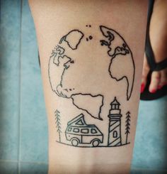 a person with a tattoo on their leg that has a drawing of the earth and lighthouse