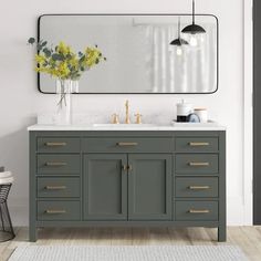 a bathroom vanity with two sinks and a large mirror over the top that hangs above it