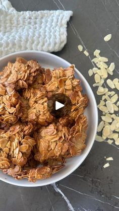 a bowl filled with granola on top of a table