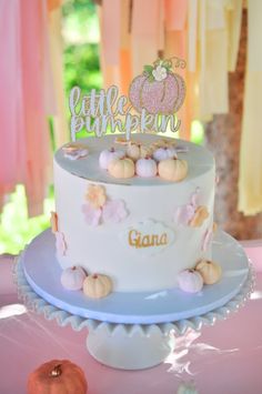 a little pumpkin birthday cake on a table