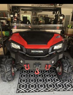 a red and black atv parked in a garage