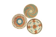 three baskets with different designs on them sitting side by side in the shape of circles