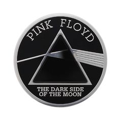 pink floyd the dark side of the moon logo on a black and silver coin with white lettering