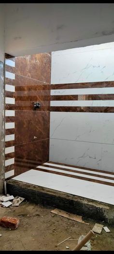 an unfinished bathroom with marble walls and floor