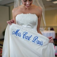 a woman in a wedding dress holding up a sign that says, miss carl davis