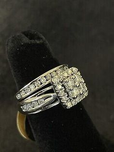 a gold ring with two rows of diamonds in it on top of a black velvet case