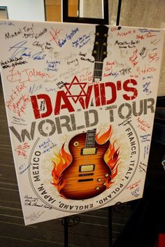 a guitar sign with the words david's world tour written on it