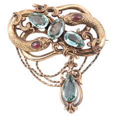 A 19th century aquamarine and garnet snake brooch/pendant, fine and elaborate chased gold finish to the body with chain,set with oval-shaped aquamarines and cabochon garnets, with red stone eyes in gold, 7cm high Weight: 21.16gr. Follow on instagram @bernardoantichita Rococo Jewelry, Snake Brooch, Large Snake, Largest Snake, Ornate Jewelry, Enchanted Jewelry, Nouveau Jewelry, Snake Jewelry, Antique Brooches