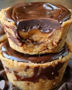 three chocolate covered cookies stacked on top of each other