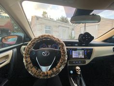 the interior of a car with an animal print steering wheel cover