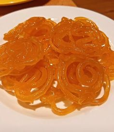 sliced orange peels are on a white plate