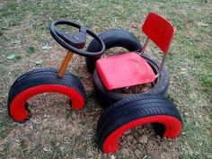 a toy car made out of tires on the ground with a steering wheel attached to it