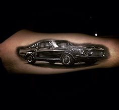 a man's arm with a black and white photo of a car on it