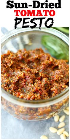 sun dried tomato pesto in a glass bowl with basil leaves on the side and text overlay