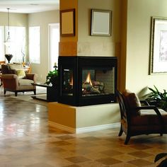 a living room filled with furniture and a fire place in the middle of the room