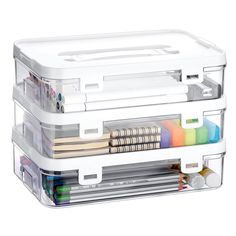 three clear storage boxes with different colored pencils and markers