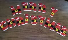 christmas decorations made out of legos on top of a wooden table with the word merry written